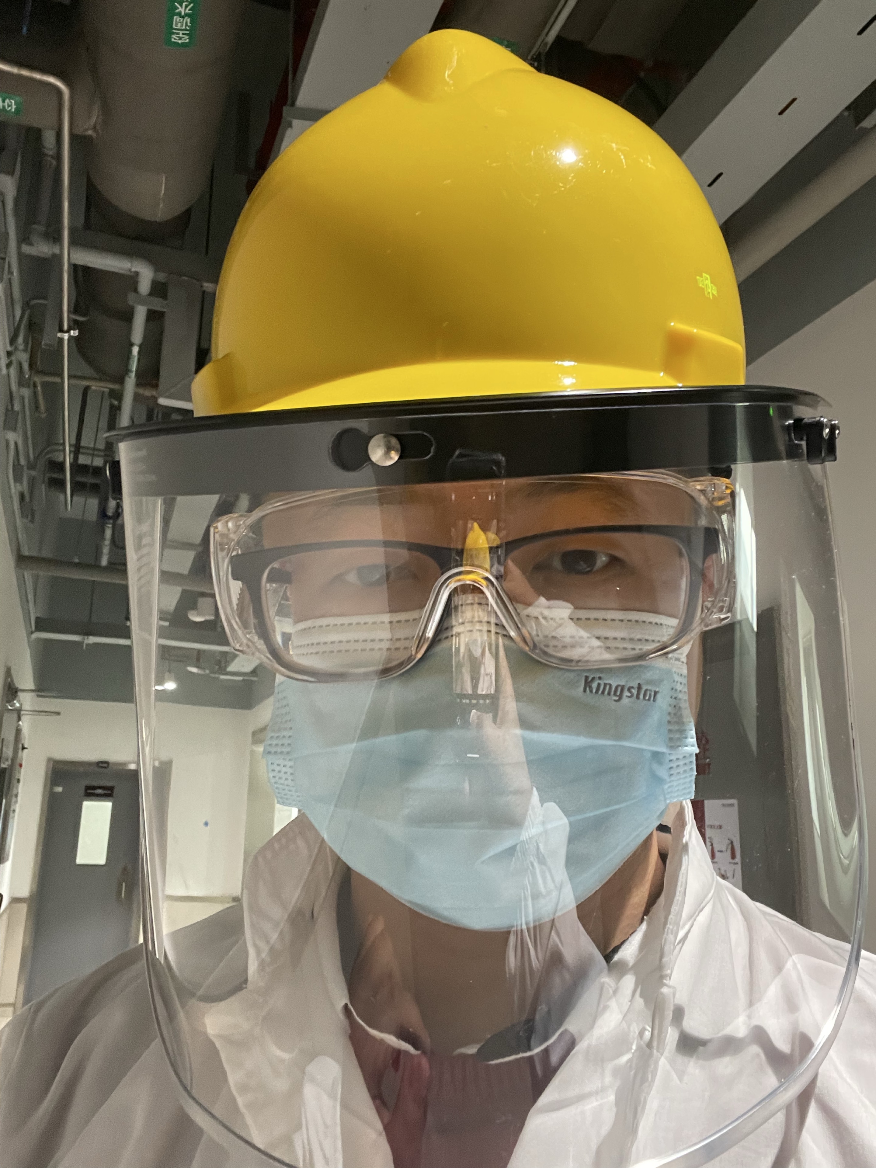Haining Wang wearing personal protective equipment at a work site